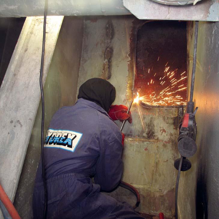 Fast underwater hull repairs save time and money for ship owners Insert ready for full penetration weld Hydrex certified welder preparing bilge plating for insert repair on container vessel Over he