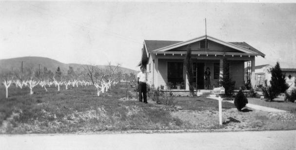 Bill Lorenz and his grandparents, September 1935. This view is looking southeast. A trolley pole is in the background, with railroad crossbucks at Electric Avenue and 40th Street.