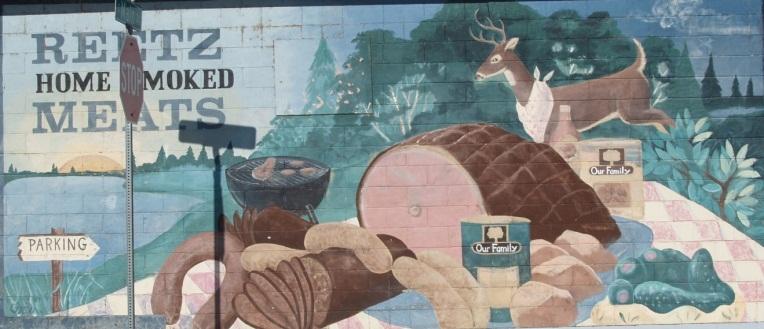 This mural shows all the activities that people do around the mill pond in Neshkoro including ice fishing, fishing, celebrating Fourth of
