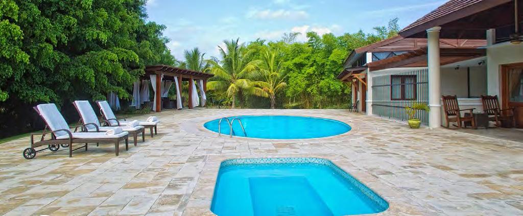 Outside, a covered patio offers shade from the warm Caribbean sun, while the pool and