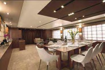 The dining area consists of a square dining table with eight chairs and opposite there is the
