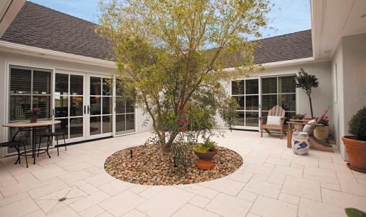Across the courtyard from the living room is the library with a fireplace, full bath and access to