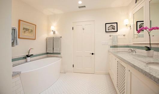 En suite master bath added in 2016 with custom cabinetry, white granite double vanity, walk-in