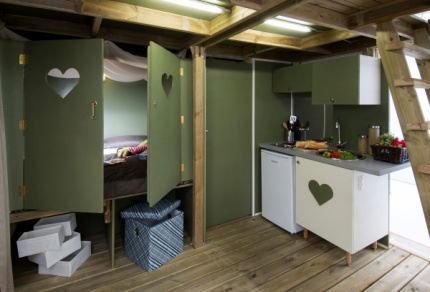 is a small bathroom equipped with shower box and sink.