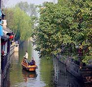 Zhouzhuang Zhouzhuang, situated between Shanghai and Suzhou, is an ancient town of Kunshan City, Jiangsu Province, abounds with rivers and lakes.