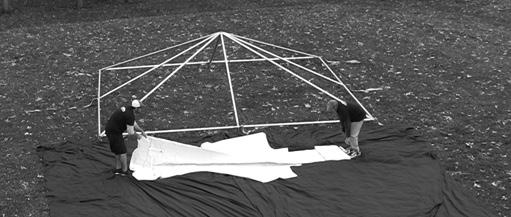 Roll out a drop cloth to protect the tent from dirt and abrasions next to the frame and unroll