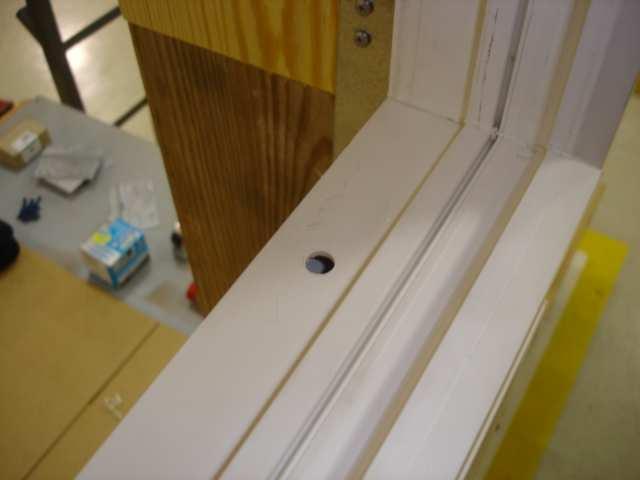 b. Install the transom window and drill clearance holes as shown (see