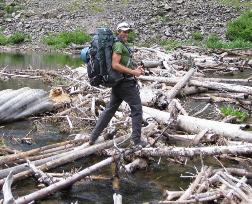 the very cold river. Above: Brett dancing across the logjam with a heavy 40+ lb. pack.