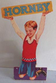 6,39 Showcard: Boy holding 'Hornby ' placard aloft
