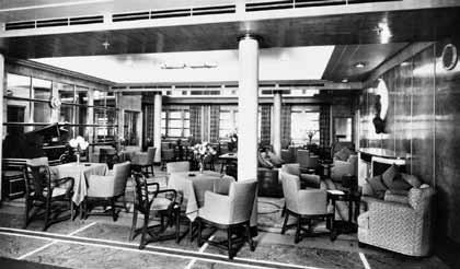 In an unusual design move for Cunard, the aft wall of the second-class Lounge was glass and looked into the staircase.