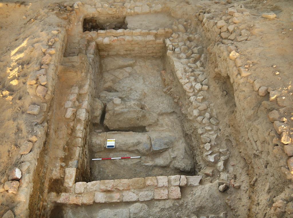 2 The northern part of trench T28 at the completion of excavations, showing the main wall of the second phase (left, partly covered) and walls with a fired brick