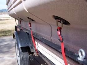 ) Once on the trailer, use the tiedown rings on the side to secure the camper to the trailer.
