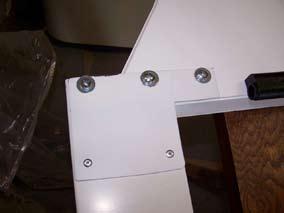 With screws removed from the header, slide the header onto the top of one the door posts with the reinforcing plate facing up, as shown in the photos at the