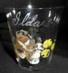 Estimate: 0 - $ 45 5 Lot # 75 - Shot Glass with painted design on one side with "Ida" etched above. On the back is etched "World's Fair St. Louis 1904". Size: 2" diameter at top by 2 1/4" tall.