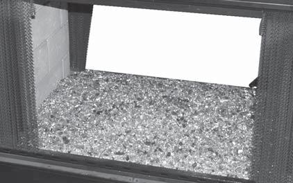 These instructions show sand granules being used as a base for the glass, but only natural-gas burners use sand. For propane burners, follow these instructions using vermiculite.