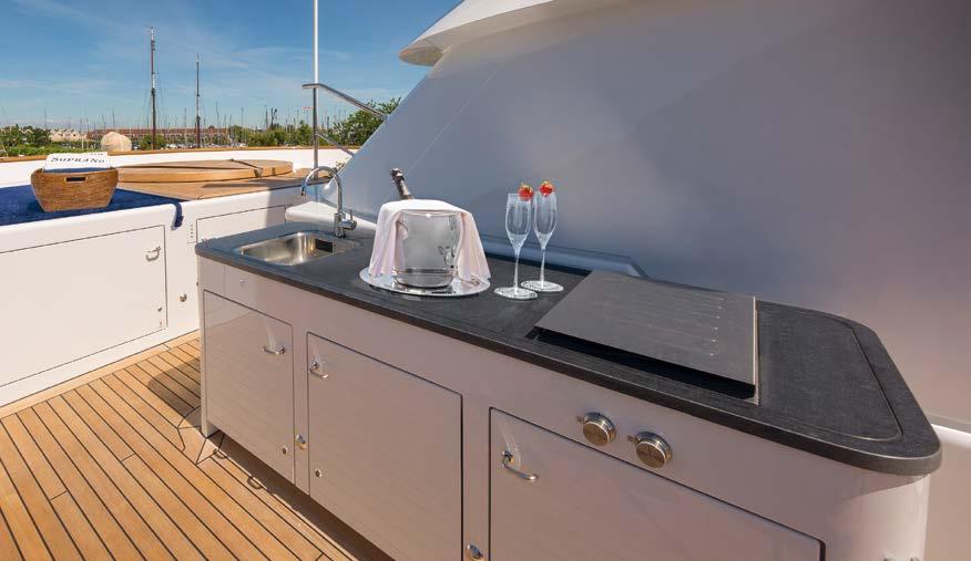 One floor higher, the bridge deck aft features an oval outdoor dining area centred on a table that seats ten.