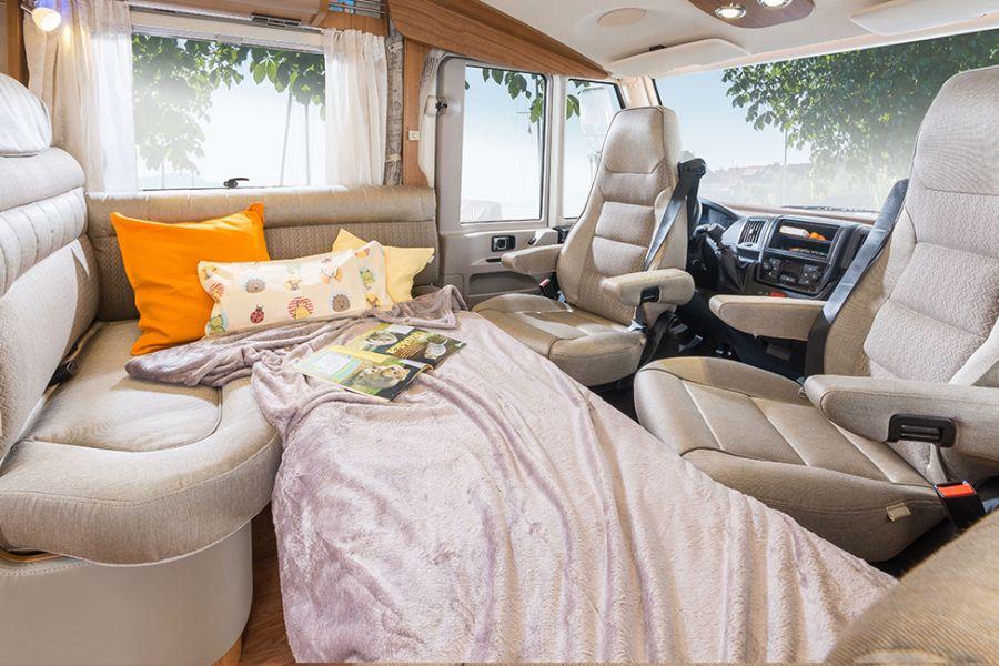 A place to sleep In the Hymermobil PremiumLine models, an additional berth can be optionally created using an extra cushion by lowering the table and incorporating the couch.