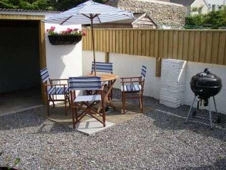 Garden The sunny patio garden offers privacy and is equipped with comfortable furniture and