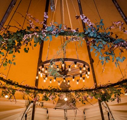 HANGING WOODEN CARTWHEEL WITH FESTOONS Beautiful when hung simply on their own, these characteristic cartwheels with glowing festoon lights create a rustic focal point.