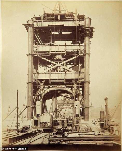 A view of the bridge: The sturdy steel frame of Tower Bridge can be seen, before it was covered with its distinctive stone-cladding on the orders of architect John Wolfe-Barry They included records