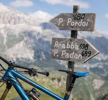 Ski lifts are happy to transport bikes up the slopes so that riders can bomb back down again. And, of course, a photo in front of the famous Passo Pordoi sign is almost obligatory.