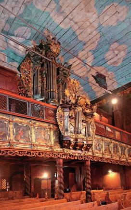 The interior is adorned with a colourful altar with six exchangeable pictures, the choir benches arranged like an amphitheatre, and it boasts excellent acoustics.