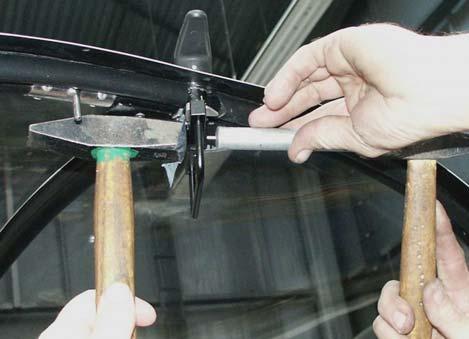 Set the handle pivot into the canopy frame from above and then slip handrail on the handle pivot from below.