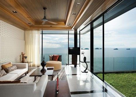 The upper floor entrance opens onto an emerald lawn from which to view the sprawling seascape below.