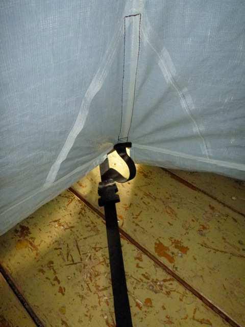 At the ground level, three belts are running from corner to opposite corner to keep the proper foot print size of the tent.