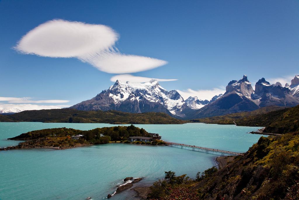 Parque Nacional Torres del Paine is a landscape dominated by soaring rock spires and tall, snow-covered peaks which also contains rolling, grass-covered hills,