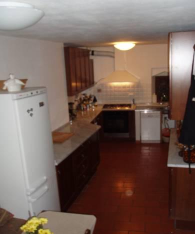 Large kitchen with table Entrance to