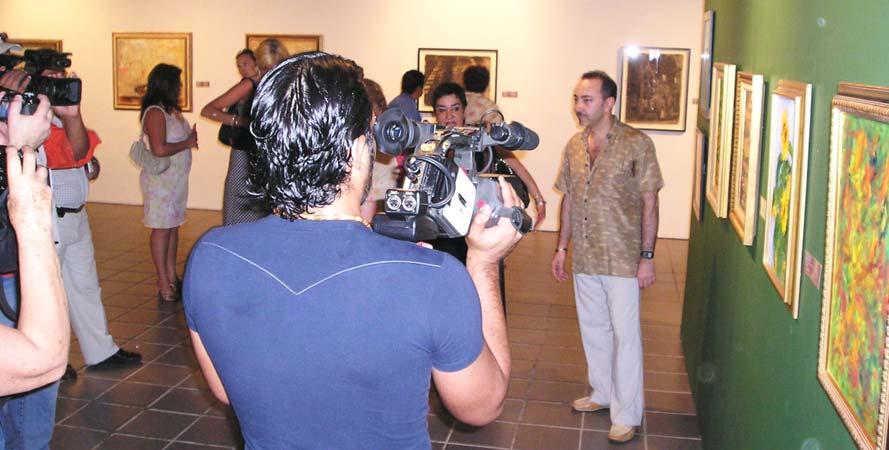 Impressionist Painter Antoine Gaber discussing his artwork with the Media during the opening of the exhibition at the Museo de la Cultura Maya in Chetumal, Mexico Parallel Passion for life program