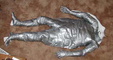 STUFFING THE DUCT TAPE DUMMY After the Ductee is taken out of the taped version of