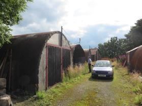 Several nissen huts, a framed building and an air raid shelter survive.