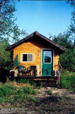 The 18 x 30 log Main Lodge is heated with a wood stove and houses the kitchen, dining room, living room, bathroom, washer and