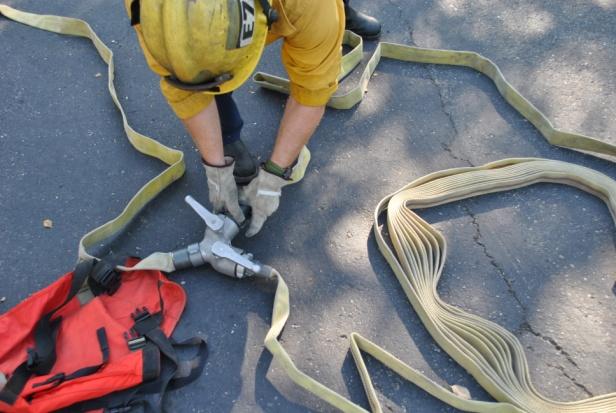 Firefighter connects trunk-line hose from the Captain s pack to the gated wye.