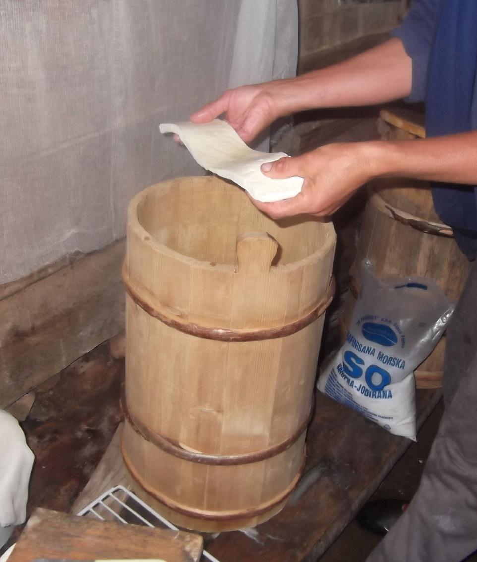 Slices are stack in buckets or wooden vats and salted during stacking.
