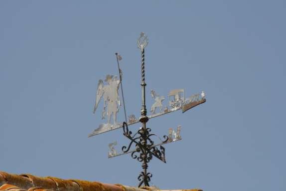 upwards namely weather vanes which, more often than not, have a symbolic relationship to the buildings they are found on top of.