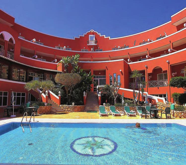 com Overlooking the bay of Praia da Luz with its sandy beach, the 4-star family-run hotel, has been built in a distinctive crescent shape and painted in a bright terracotta colour.