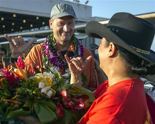 Pilot Andre Borschberg flashes a Hawaiian shaka sign to a greeter after landing the Solar Impulse 2 at the Kalaeloa Airport in Kapolei,