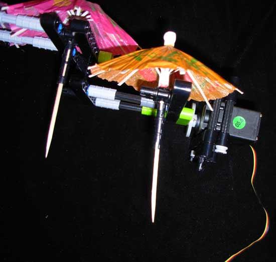 You can see in this picture that the shields (umbrellas) are sitting so that the sticks are about the same length. In our first prototype the first shield nearest to the robot was sitting lower.