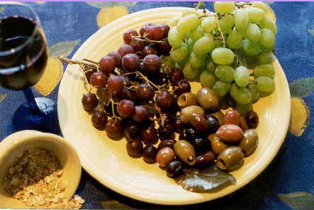 The daily diet included CEREALS (like wheat and barley), GRAPES, and OLIVES -- commonly called the MEDITERRANEAN TRIAD.