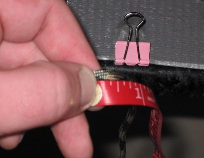 Unwrap the paracord bundle, measure the amount needed, and cut the cord.