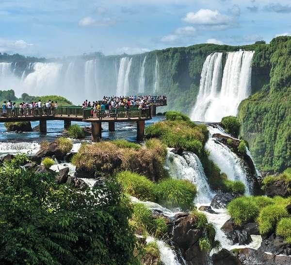 Argentina s Top 20 Iguazú Falls 2 MICHAEL RUNKEL/GETTY IMAGES The peaceful Río Iguazú, flowing through the jungle between Argentina and Brazil, plunges suddenly over a basalt cliff in a spectacular