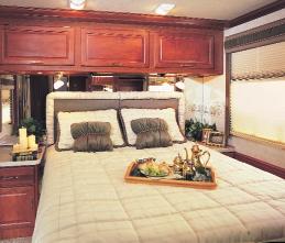 Expedition s bedroom combines warm wood cabinetry and crown molding with custom fabrics and window treatments for an extra touch