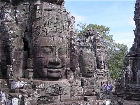 Proceed to Angkor Thom boasts a series of walls that form terraces. One wall, called the Terrace of the Leper King, features a statue of a king sitting atop the terrace.