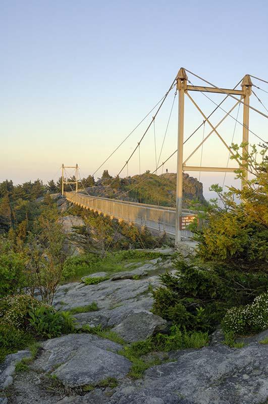 Mile High Swinging Bridge The Mile High Swinging Bridge was built to give visitors easy access to the breath-taking view from Grandfather Mountain's Linville Peak.