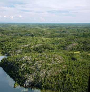 This typical landscape in the Rutledge Upland HB Ecoregion shows exposed hummocky bedrock, sparse jack pine and black spruce forests, rock-walled