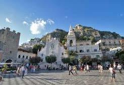 Take a 30 minute ferry to Messina and then transfer to Taormina.