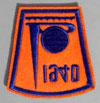Lot # 233 - Embroidered cloth patch, blue stitching on an orange background of the Trylon & Perisphere with "1940" above. Size: 3 1/8"" high by 3 1/8" at the widest. Condition:Excellent.